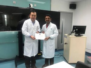 Dr. Niranjanan recieving his fellowship certificate from Prof Yu Bin Sheng